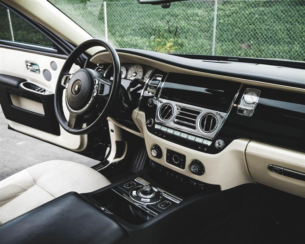 The dashboard and steering wheel of a saloon car