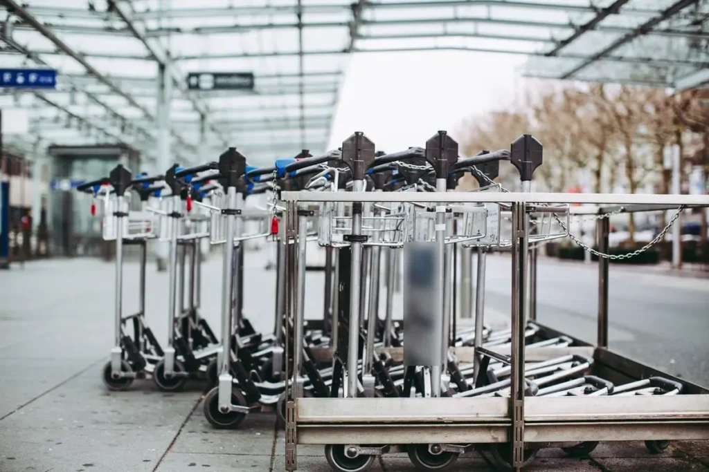 Luggage trolleys lined up outside an airport terminal