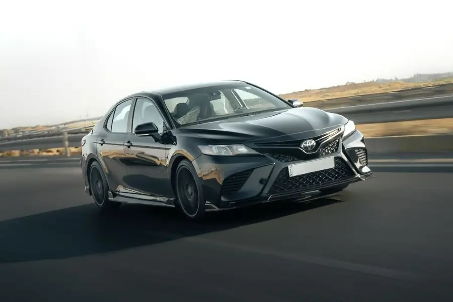 A Toyota Camry driving on a highway
