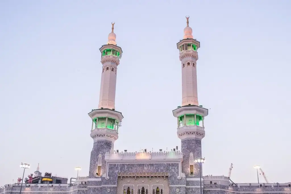 Two minarets of Masjid al-Haram in Makkah against the dusk sky