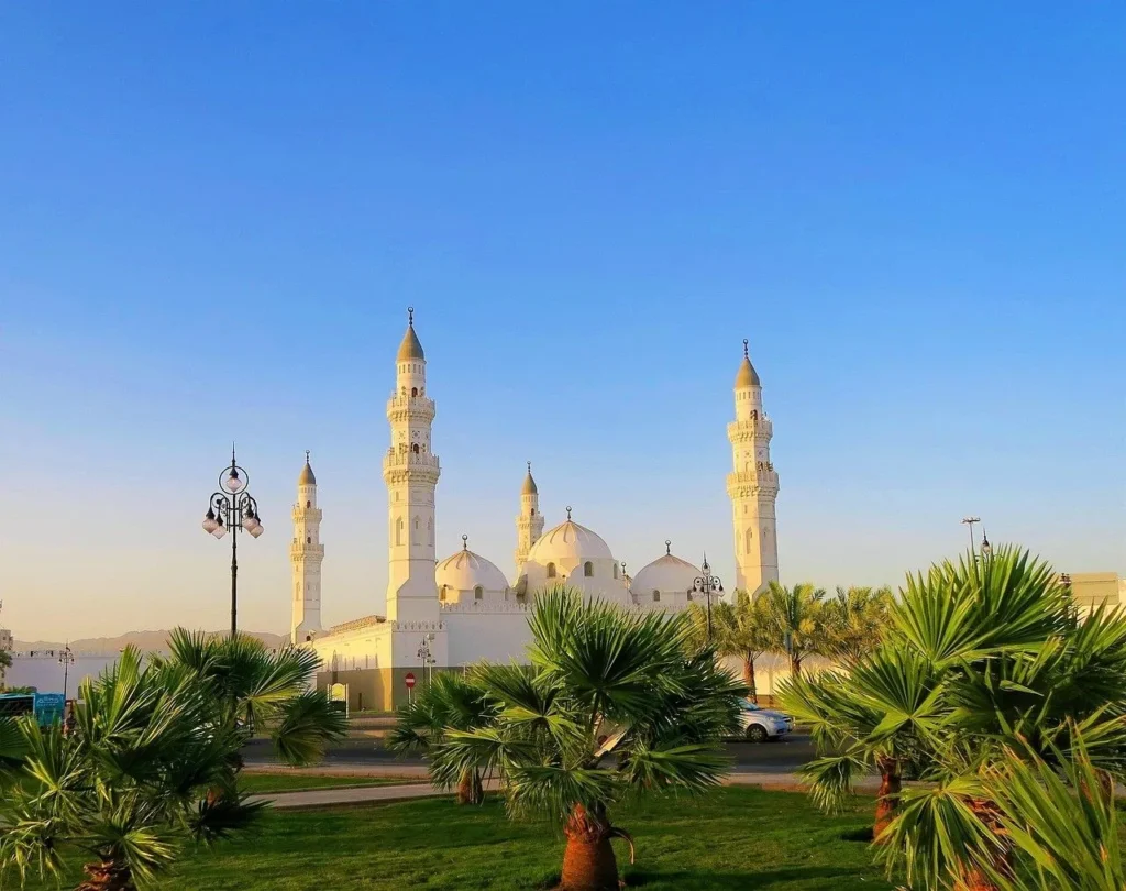 Masjid Quba in Madinah with palms in front and a clear sky