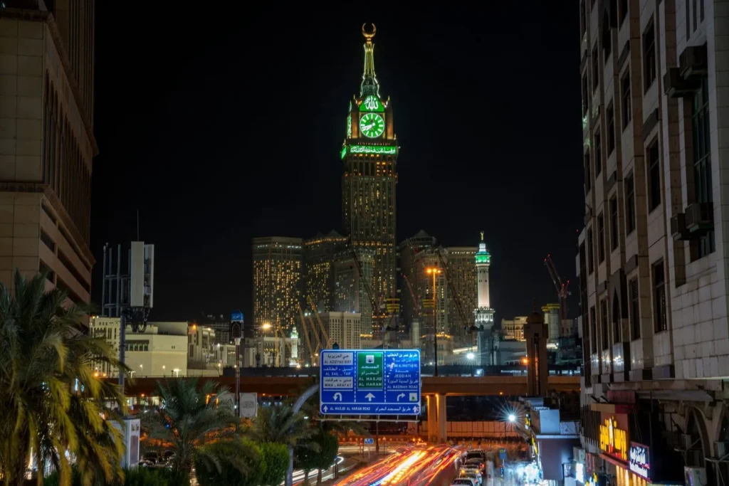 Road into central Makkah at night with the clock tower ahead
