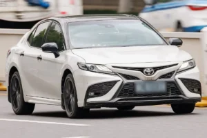 A white Toyota Camry, front three quarter view