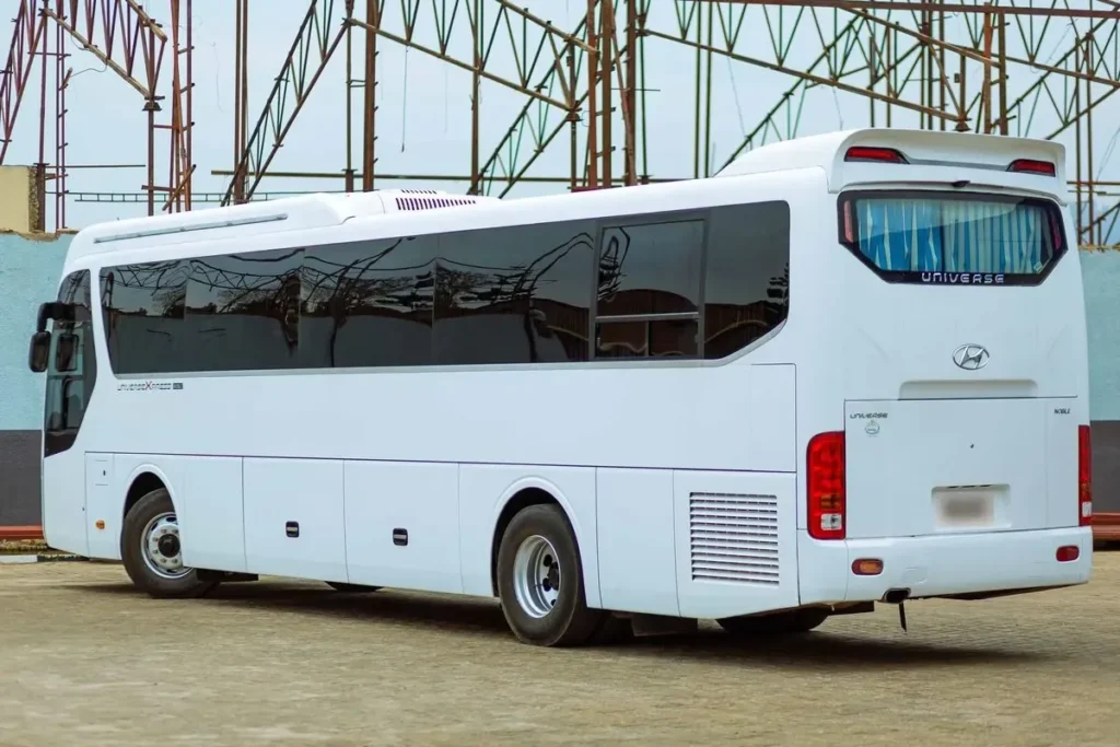 A white Hyundai Universe coach, rear three quarter view