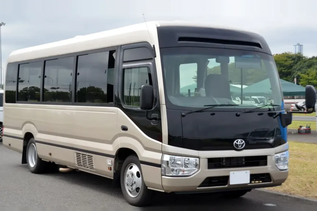 A Toyota Coaster minibus, front three quarter view