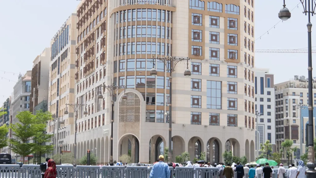 Street beside a hotel near Masjid an-Nabawi, Madinah, with people walking