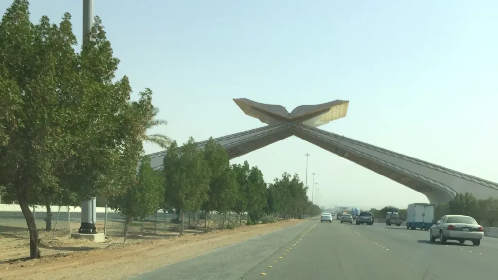 The Quran Gate (Makkah Gate) arch over the Jeddah to Makkah expressway, with traffic heading toward Makkah