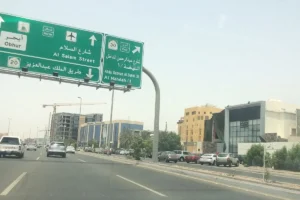 Green direction signs over King Abdulaziz Road, Jeddah, pointing to Obhur, Al Salam Street and the airport