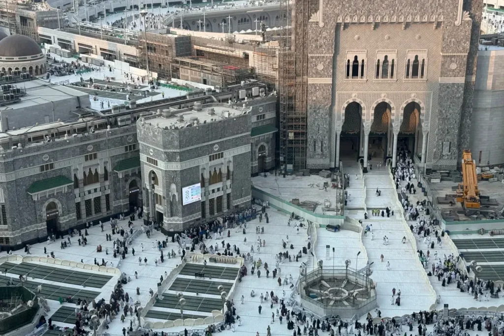 Gate and outer courtyard of Masjid al-Haram, Makkah, seen from above with people walking