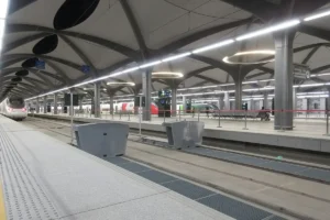 Platform at Madinah station on the Haramain High Speed Railway, with a train at the far end
