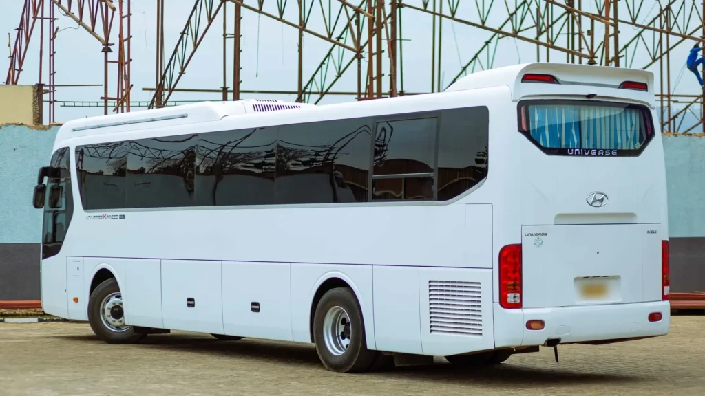 White Hyundai Universe full size coach, rear three quarter view; photographed outside Saudi Arabia, foreign licence plate blurred by us