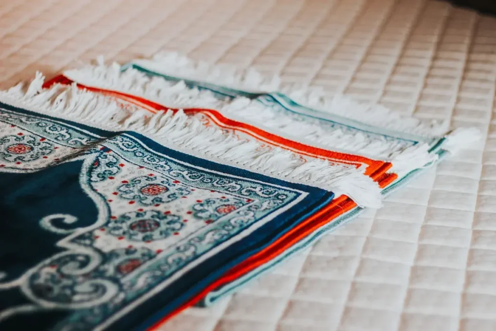 Folded prayer mats, no people; generic
