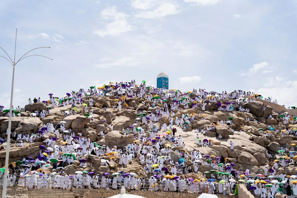 Jabal al-Rahmah at Arafat covered in pilgrims in white with umbrellas