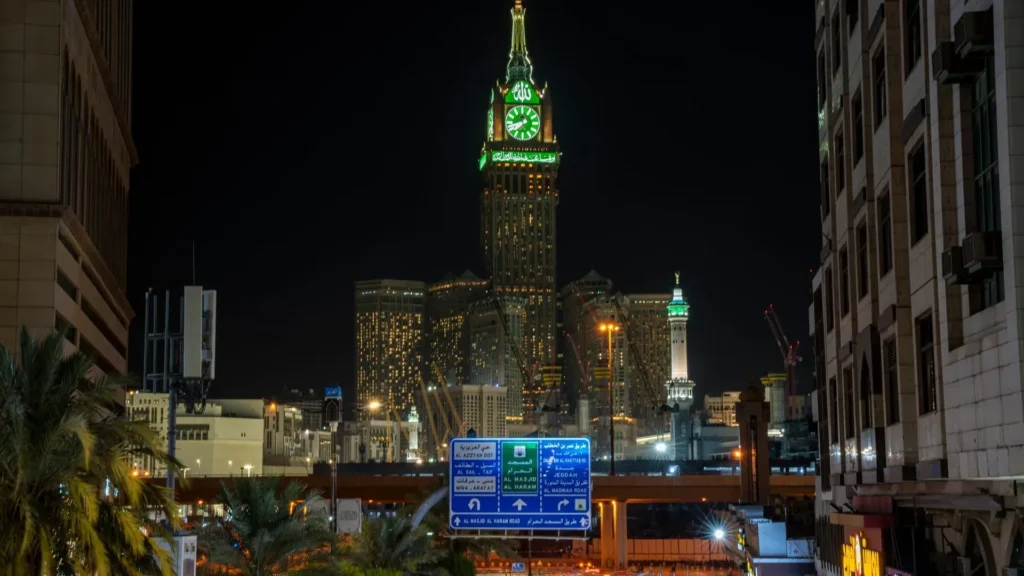 Road into central Makkah at night with the Makkah Clock Royal Tower and traffic light trails