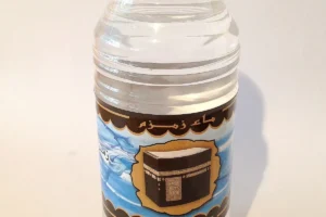 Small plastic bottle labelled Zamzam water, close up