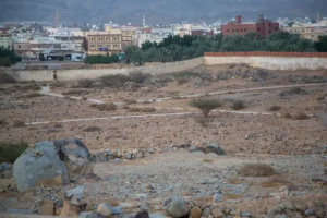 The walled cemetery of the martyrs of Badr seen from outside, the town of Badr behind