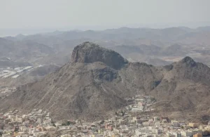 Jabal al-Nour seen from a distance, its flat topped peak rising above the houses of Makkah