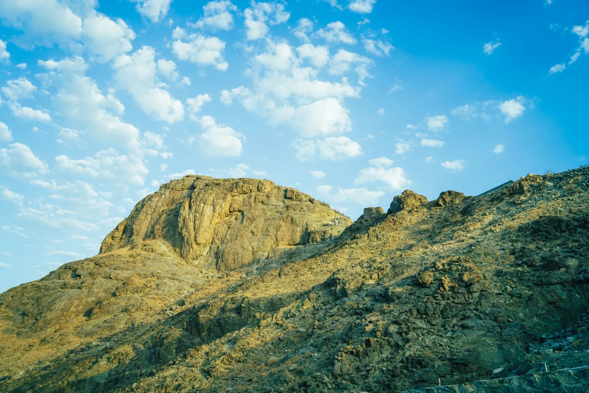The rocky summit of Jabal al-Nour in Makkah under a blue sky with scattered cloud