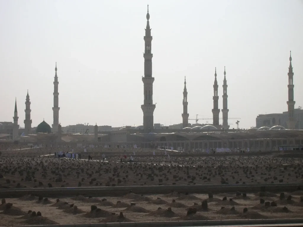Jannat al-Baqi cemetery in Madinah seen from a distance, the minarets of Masjid an-Nabawi beyond