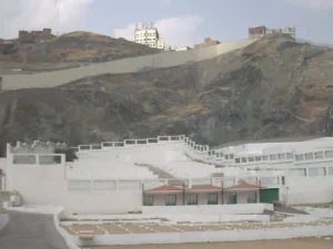 The terraced white walls of Jannat al-Mualla against the hillside