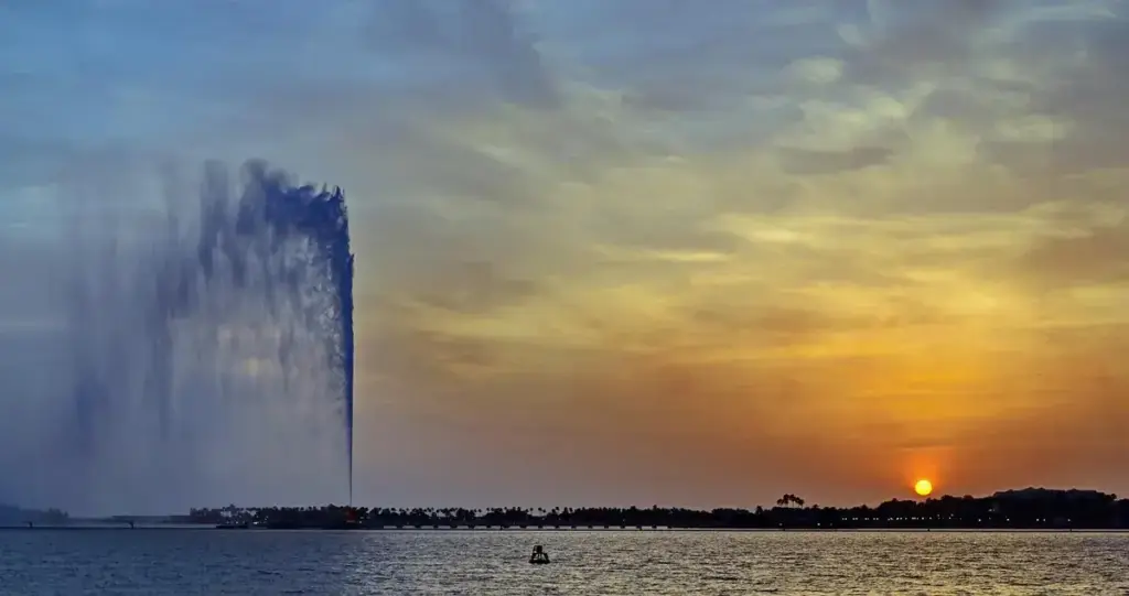 King Fahd Fountain on the Jeddah Corniche against a sunset sky over the Red Sea