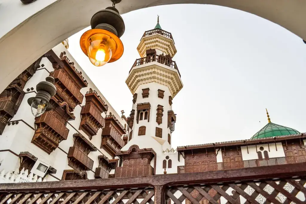 A minaret in Al Balad, Jeddah, framed by an arch and wooden balconies