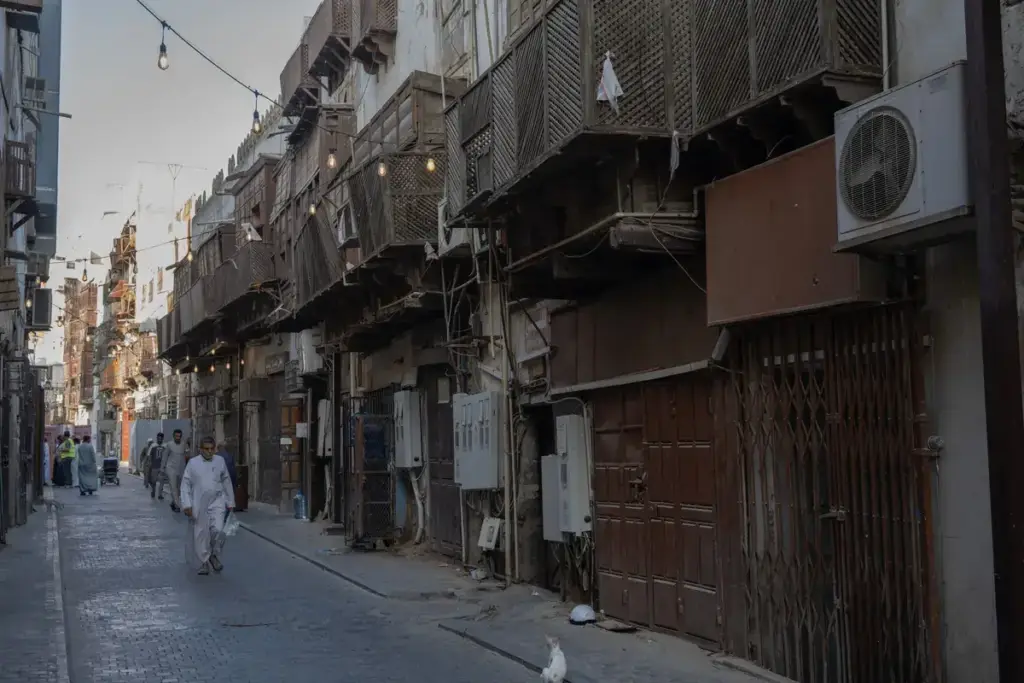 A narrow street of tall old houses with wooden balconies in Al Balad, Jeddah