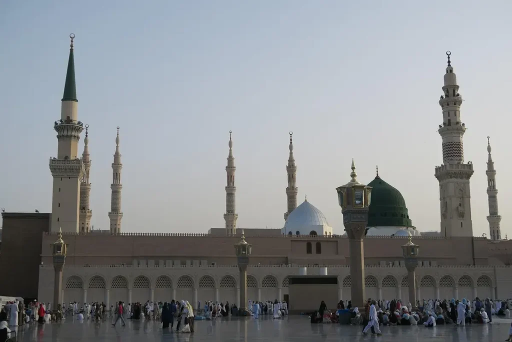 The walls and minarets of Masjid an-Nabawi from the courtyard