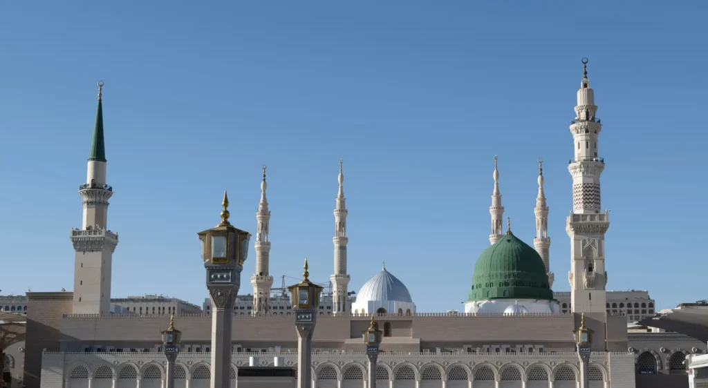 Masjid an-Nabawi in Madinah with the Green Dome and its tall minarets under a clear blue sky
