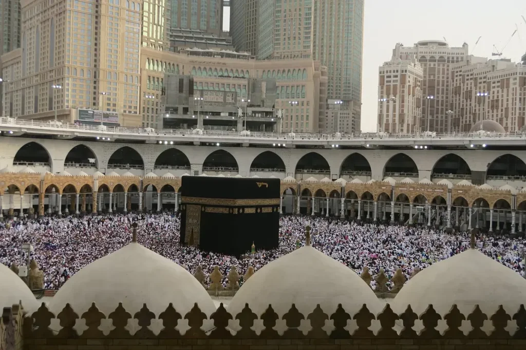 The Kaaba and the courtyard of Masjid al-Haram seen from an upper level, crowds far below
