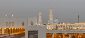Masjid al-Qiblatayn at dusk with both minarets lit