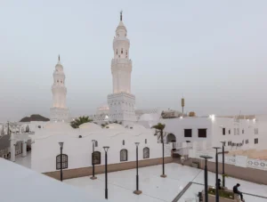 The two white minarets of Masjid al-Qiblatayn in Madinah above the mosque roof terrace