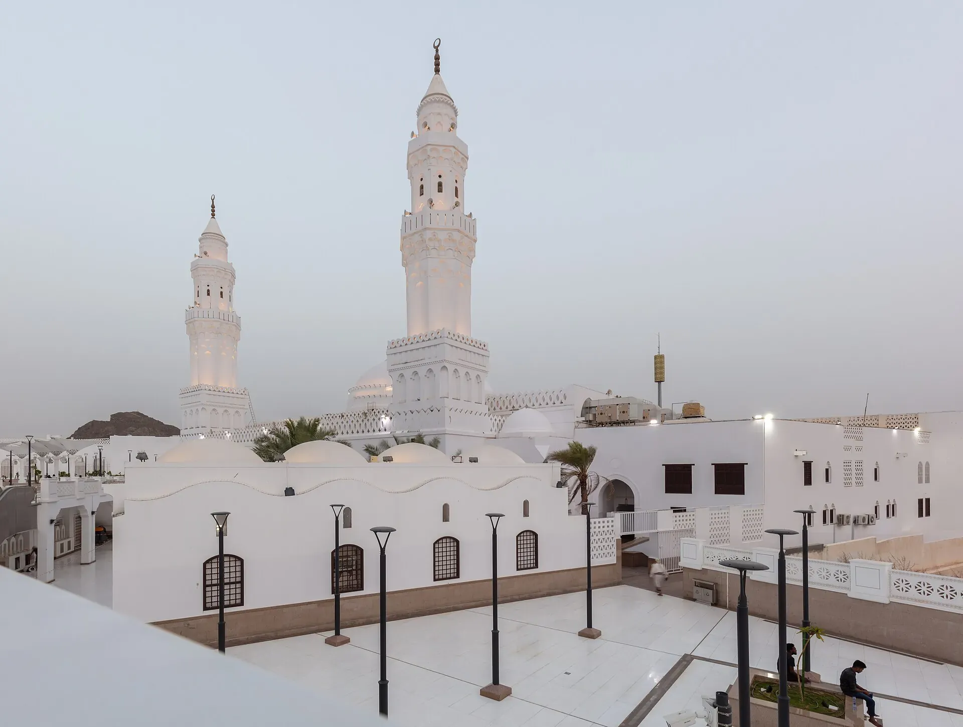 The two white minarets of Masjid al-Qiblatayn in Madinah above the mosque roof terrace
