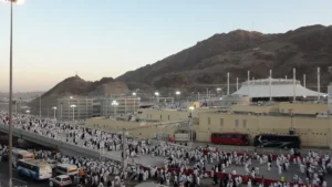 Pilgrims walking toward the multi level Jamarat Bridge in Mina, seen from a distance