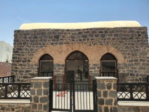 The black stone front of the Mosque of Salman al-Farisi at the Seven Mosques