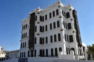 Shubra Palace in Taif, a white four storey building with dark wooden mashrabiya
